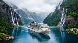 Luxury cruise ship sailing through a narrow green fjord in Norway with waterfalls