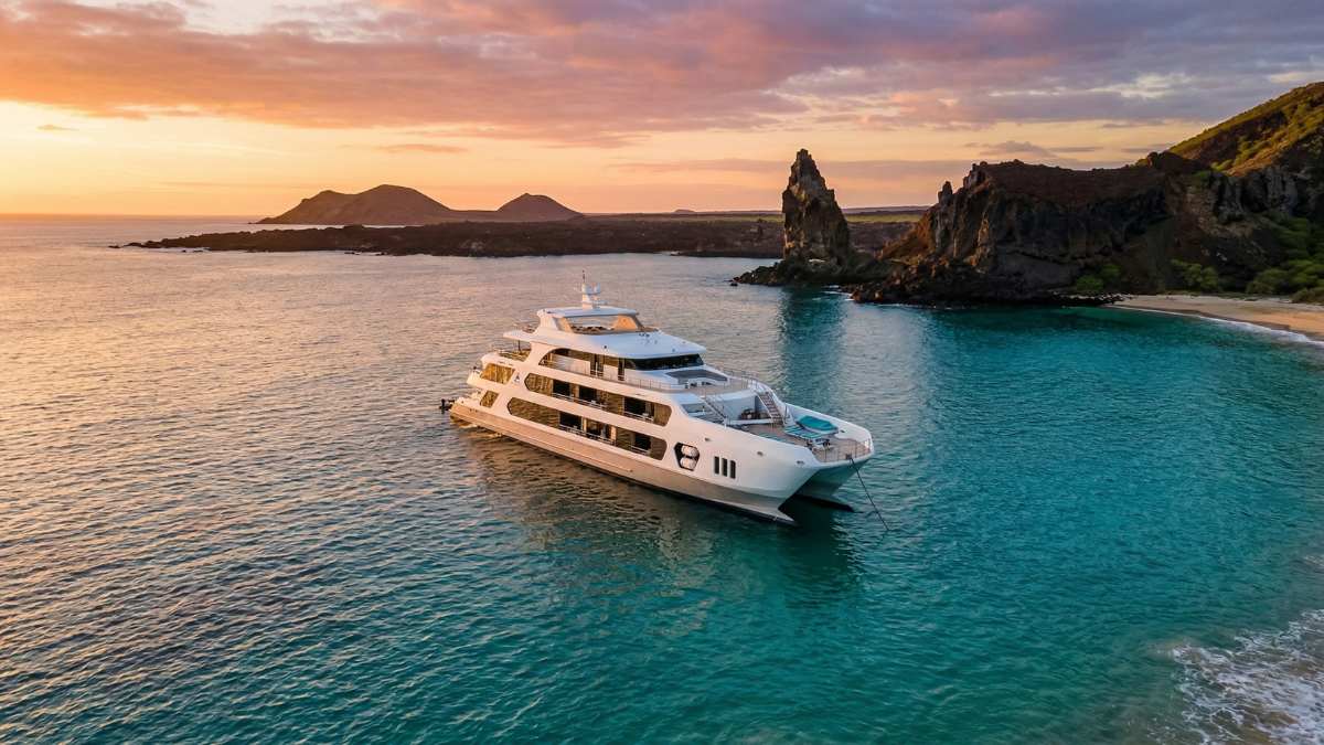 Couples relaxing on private balcony suite on the best Galapagos cruise for couples